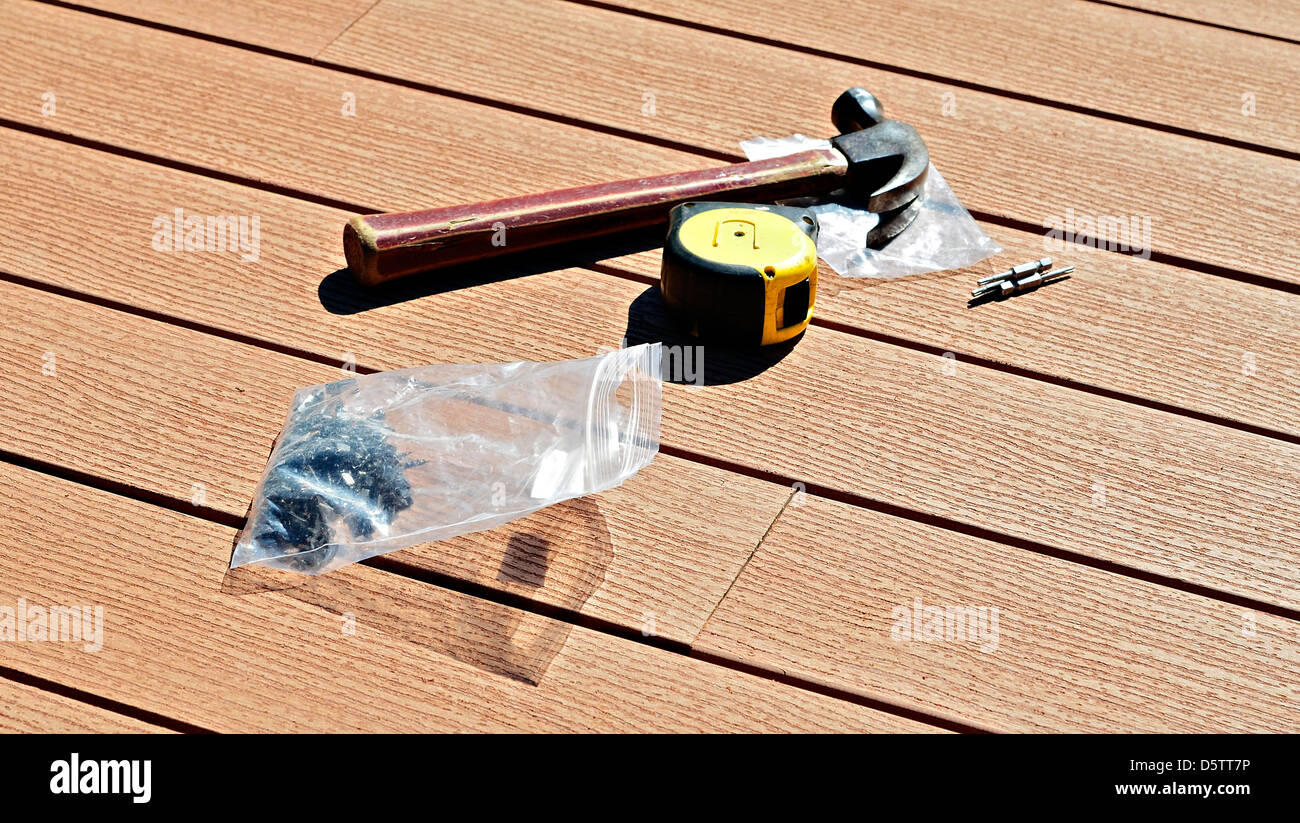 Tools for installing a composite wood floor. Stock Photo