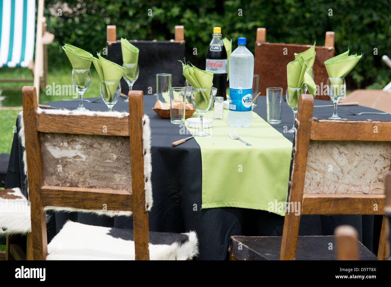 Table setting with chairs covered in hunted furs and skins on a farm in Rancagua, Chile Stock Photo