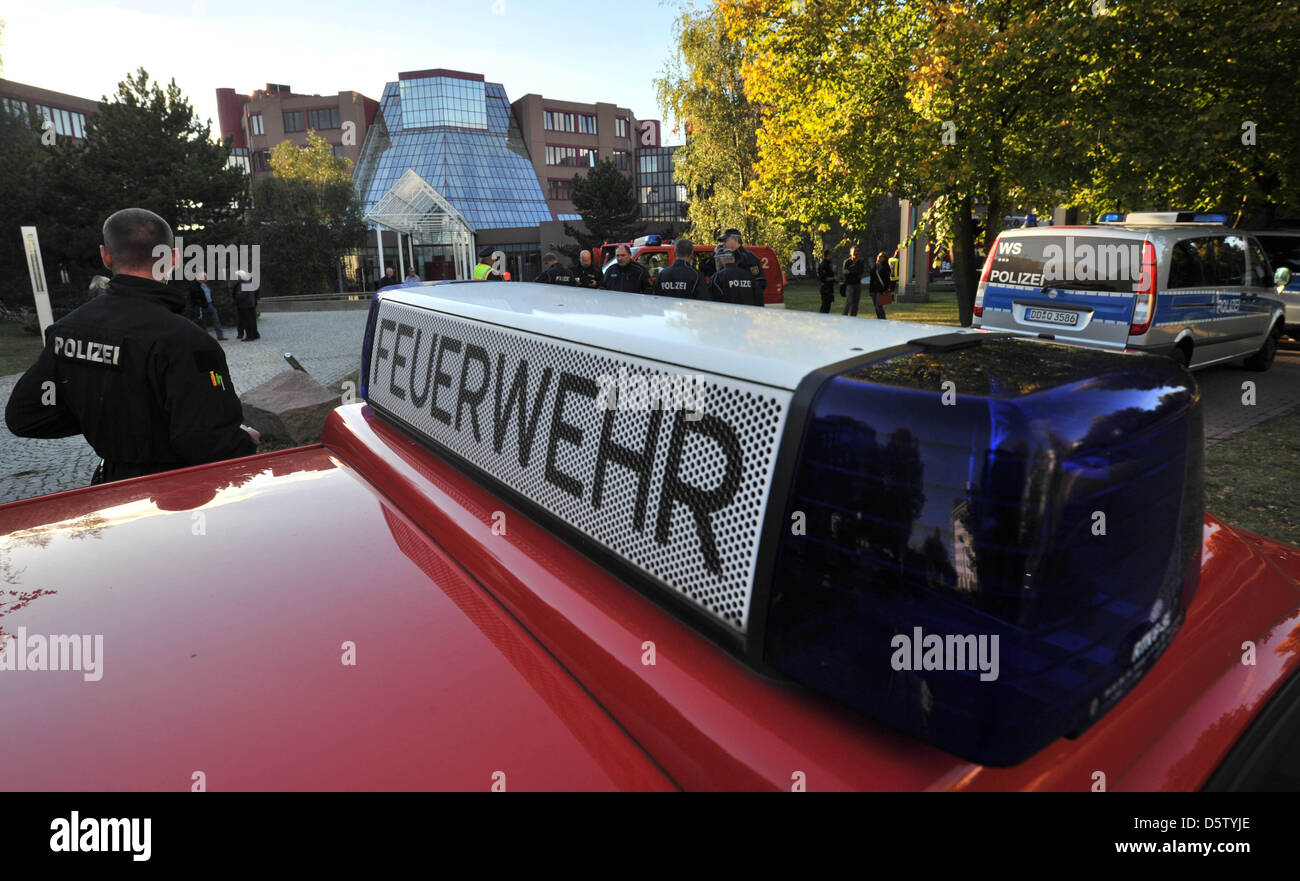 Emergency forces help as employees of a Deutsche Bank base leave their workplace in security clothes in Schkanditz, Germany, 28 September 2012. An envelope with white powder was found in the post. It is yet unclear whether the envelope contains the dangerous anthrax virus. 700 people were evacuated from the building. Photo: HENDRIK SCHMIDT Stock Photo