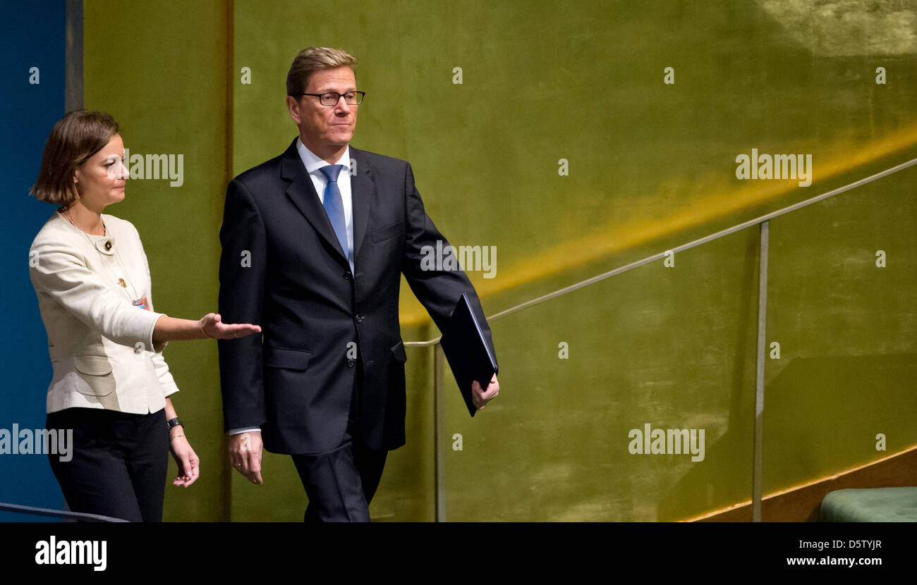 German Foreign Minister Guido Westerwelle (r) enters the plenary hall to speak in front of the General Assembly of the United Nations in New York, USA, 28 September 2012. Westerwelle focused on conflicts in Syria and Iran. The woman in the picture is not identified. Photo: SVEN HOPPE Stock Photo
