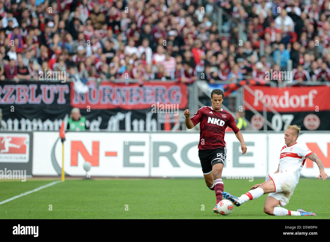 Stuttgart's Raphael Holzhauser (R) vies for the ball with Nuremberg's Timothy Chandler during the German Bundesliga match between FC Nuremberg and VfB Stuttgart at easyCredit Stadium in Nuremberg, Germany, 29 September 2012. The final score was 0-2. Photo: DAVID EBENER  (ATTENTION: EMBARGO CONDITIONS! The DFL permits the further utilisation of up to 15 pictures only (no sequntial p Stock Photo