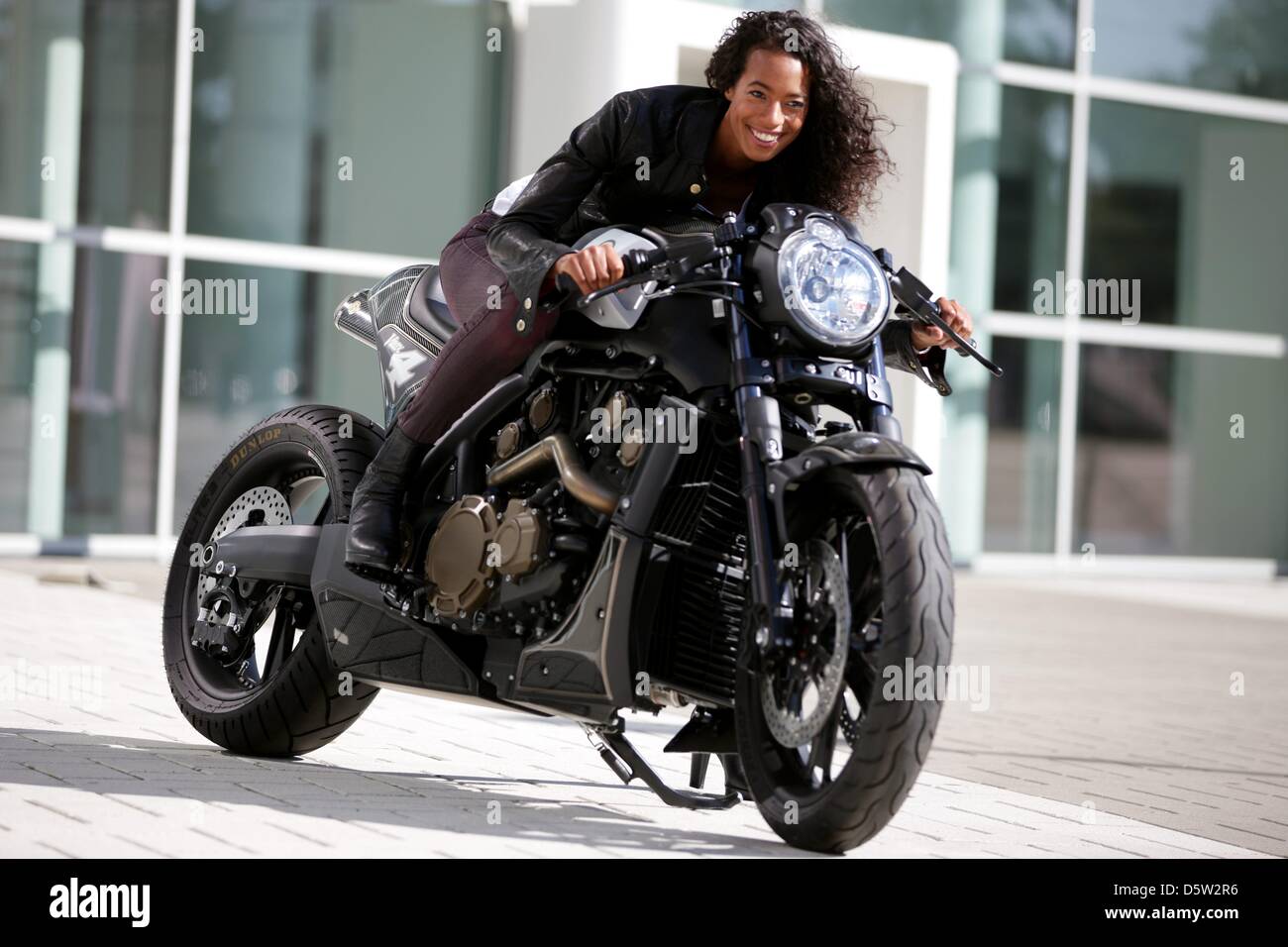 Model Anne sits on a modified Yamaha V-Max by Roland Sands during a photocall for the motorcycle trade fair INTERMOT in Cologne, Germany, 01 October 2012. Photo: ROLF VENNENBERND Stock Photo