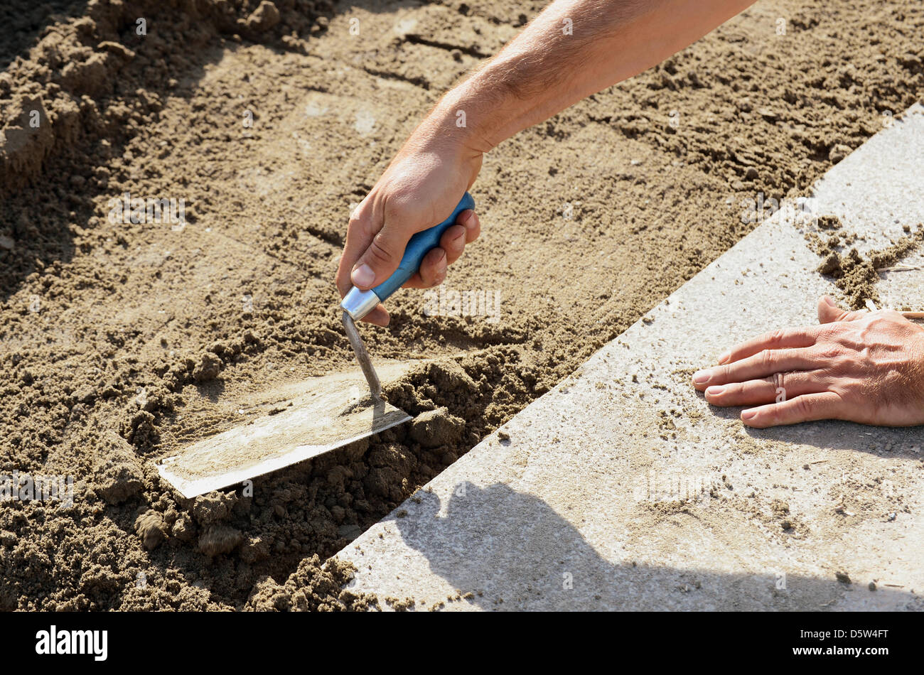 A man works with a trowel at Tempelhof Field in Berlin, Germany, 02 October 2012. Photo: Britta Pedersen Stock Photo