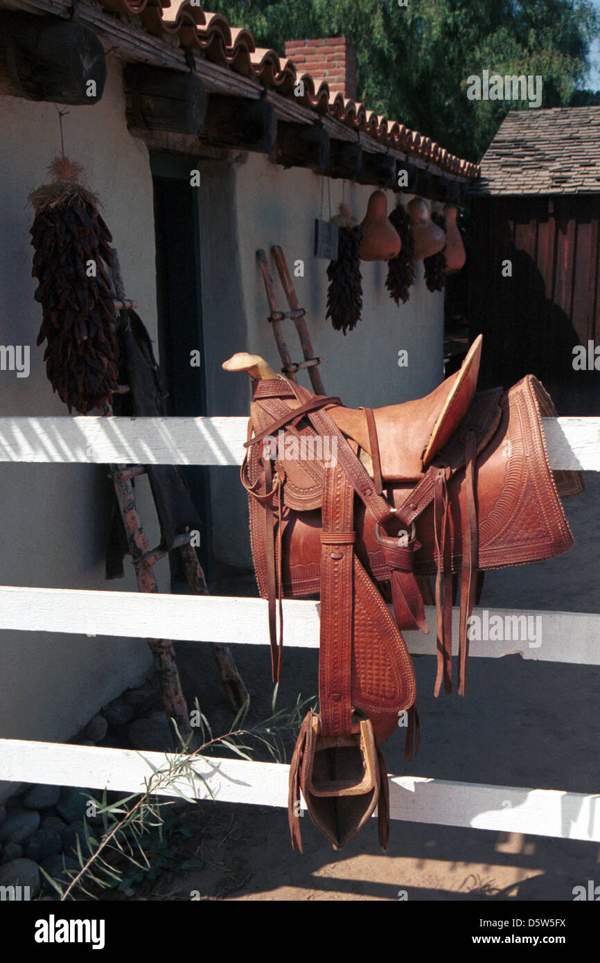 Mexican saddle on fence at adobe home San Diego California, Mexican