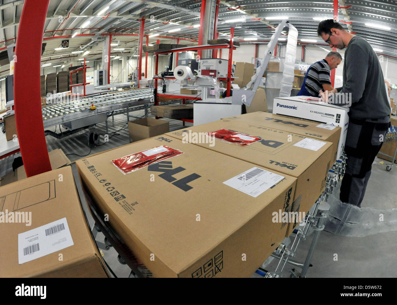 Employees prepare parcels for delivery at the new logistics centre for consumer electronics of the online retailer redcoon in Erfurt, Germany, 04 October 2012. The centre opened at the start of September and will provide 200 jobs. Photo: Martin Schutt Stock Photo