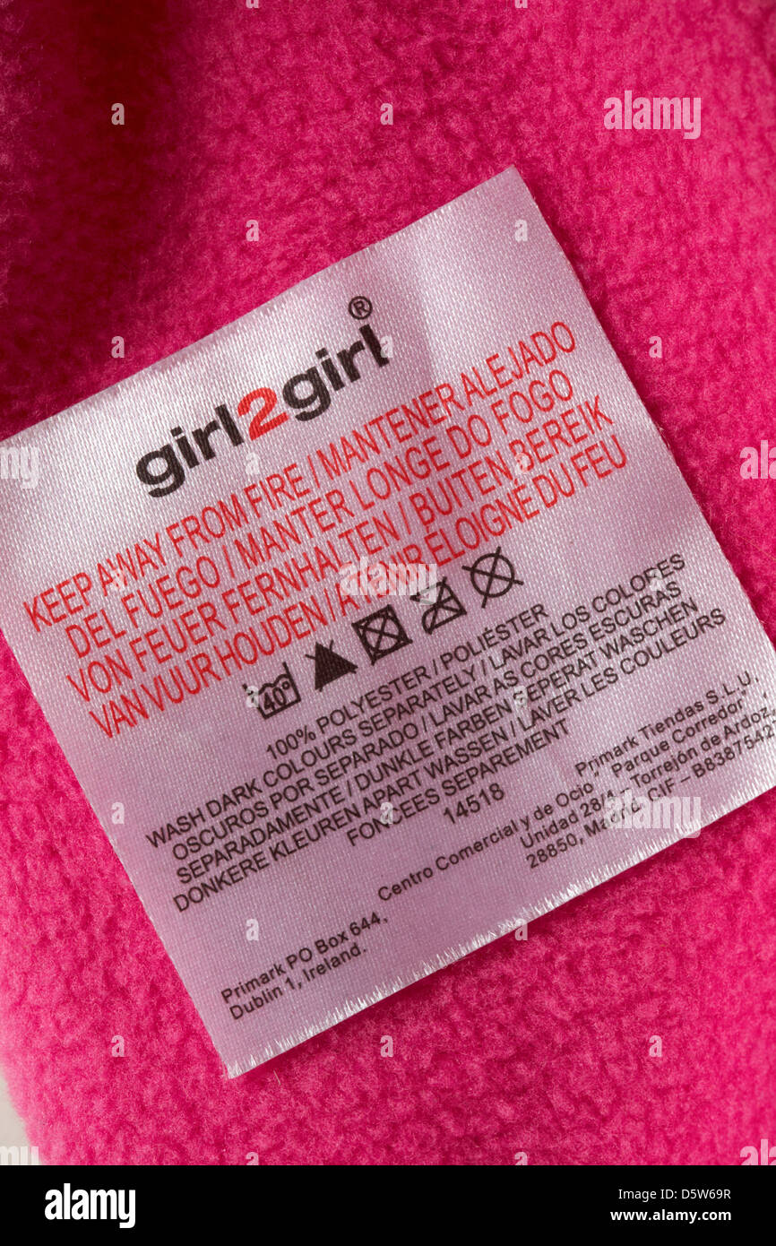 label in girl2girl garment 100% polyester, keep away from fire - care  washing symbols and instructions Stock Photo - Alamy