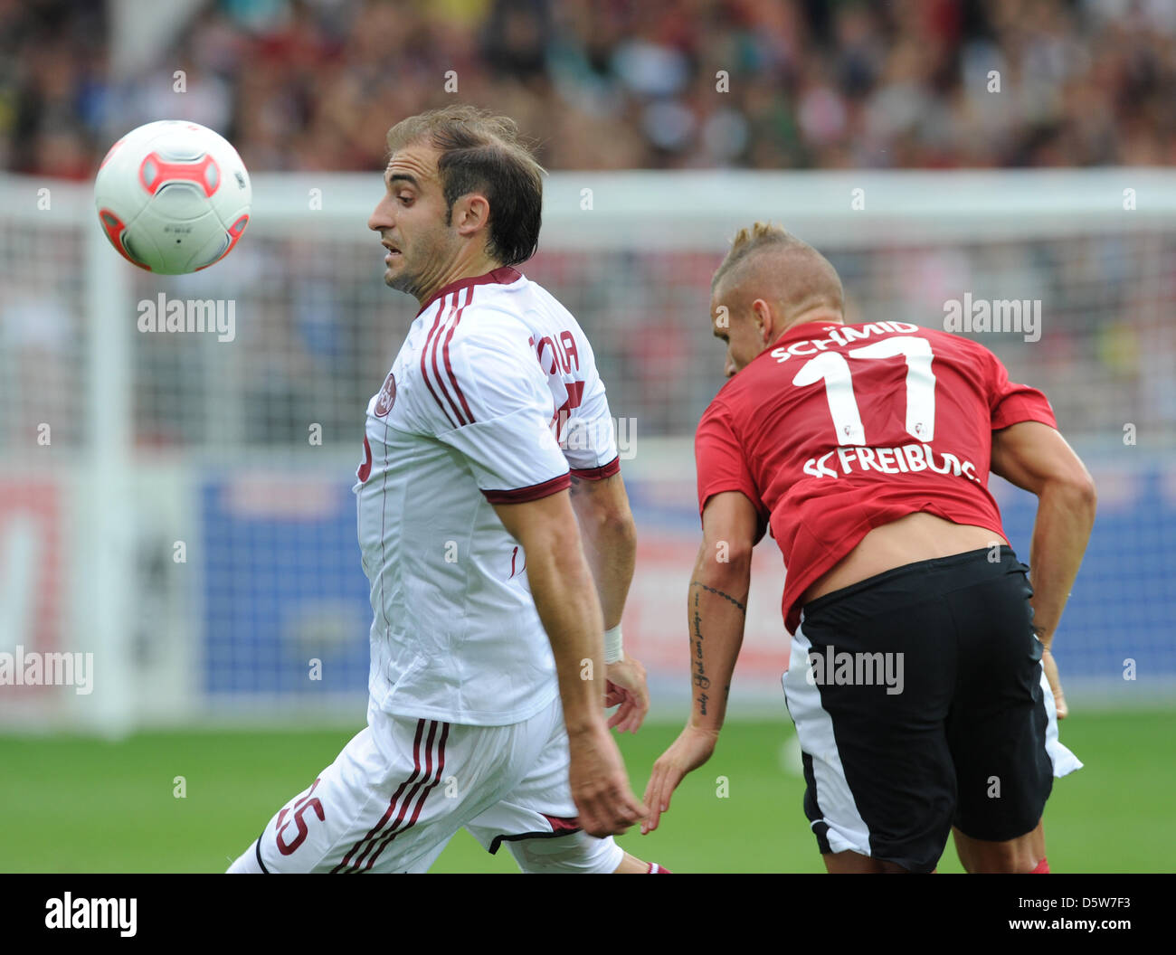 Freiburg's Jonathan Schmid (R) vies for the ball with Nuremberg's Javier Pinola during the German Bundesliga match between SC Freiburg and FC Nuremberg at Mage Solar Stadium in Freiburg, Germany, 06 October 2012. Photo: ULI DECK (ATTENTION: EMBARGO CONDITIONS! The DFL permits the further utilisation of up to 15 pictures only (no sequntial pictures or video-similar series of picture Stock Photo