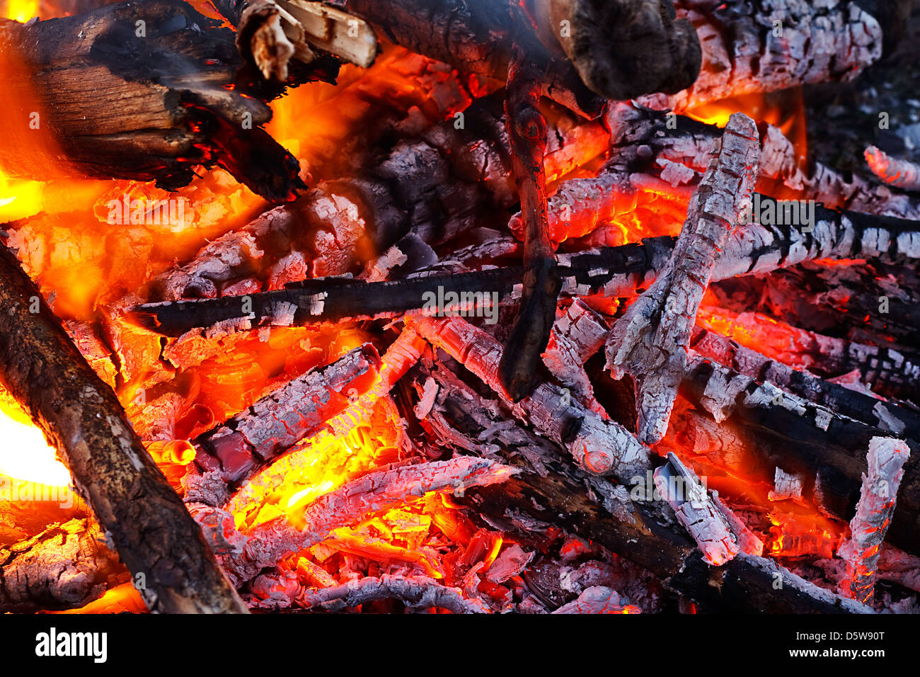 natural wood log fire embers glowing great for background or in solid fuel stoves now classed as a renewable power source Stock Photo