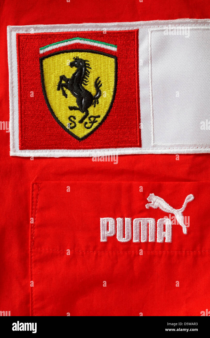 Puma and Scuderia Ferrari racing shield  logos on red top Stock Photo
