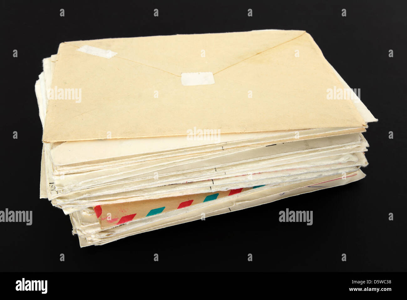 Stack of old letters on black background. Stock Photo