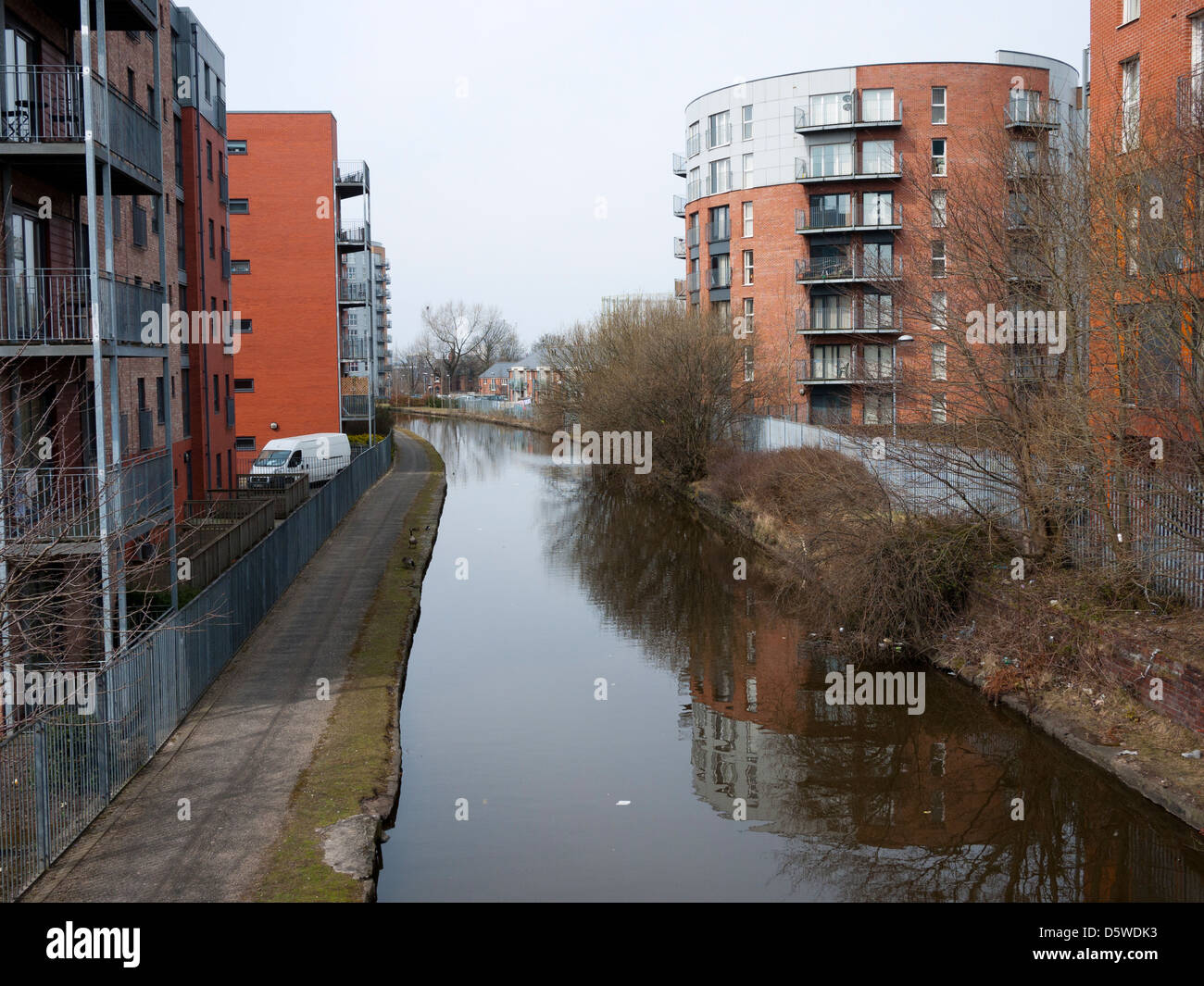 The Ashton Canal winds between high rise flats, Manchester, UK Stock