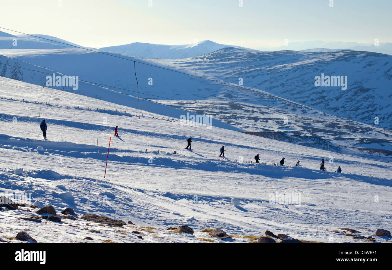 Skiers & snowboarders seen from the Ptarmigan viewing terrace, Cairngorm Mountain Ski Centre, Aviemore, Highlands,Scotland UK Stock Photo