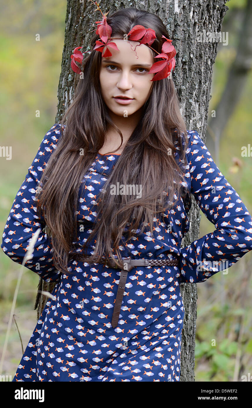 The beautiful girl stands a tree Stock Photo - Alamy