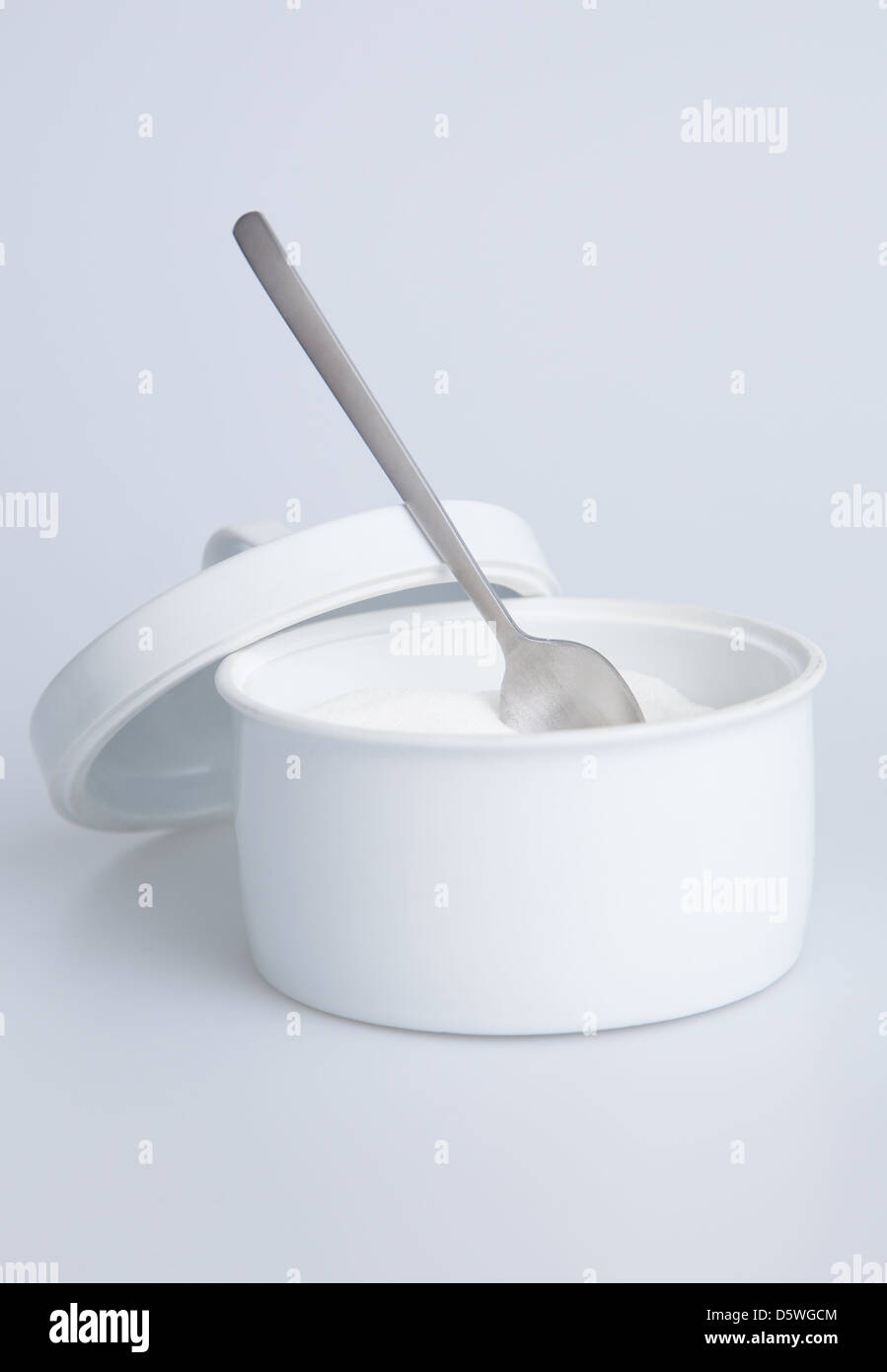 White sugar container with silver spoon Stock Photo