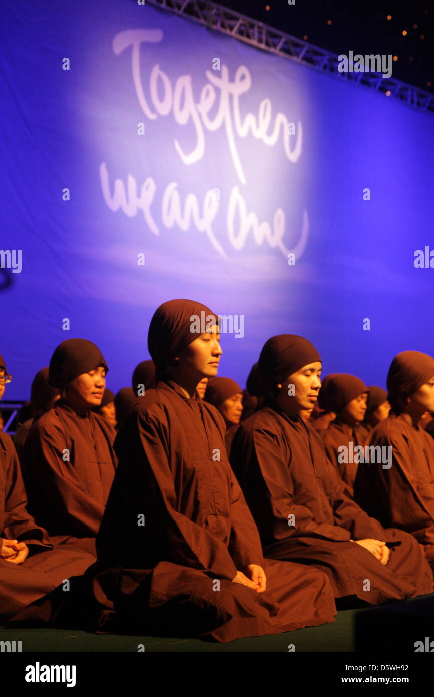 Bangkok, Thailand. 9th April 2013.  Nuns from Plum Village during meditation .  Zen master Thich Nhat Hanh giving a public Dhamma talk at Siam Paragon in Bangkok  as part of an Asia Teaching Tour, hosted by the Thai Plum Village Foundation. Zen master Thich Nhat Hanh arrives in March to begins a five-week visit in Thailand, during which he will lead vipassana training and open an exhibition of calligraphic meditation. The Vietnamese holy man and 50 followers from France will host a series of spiritual activities during his fifth visit to Thailand . credit: Piti A Sahakorn /Alamy Live News Stock Photo