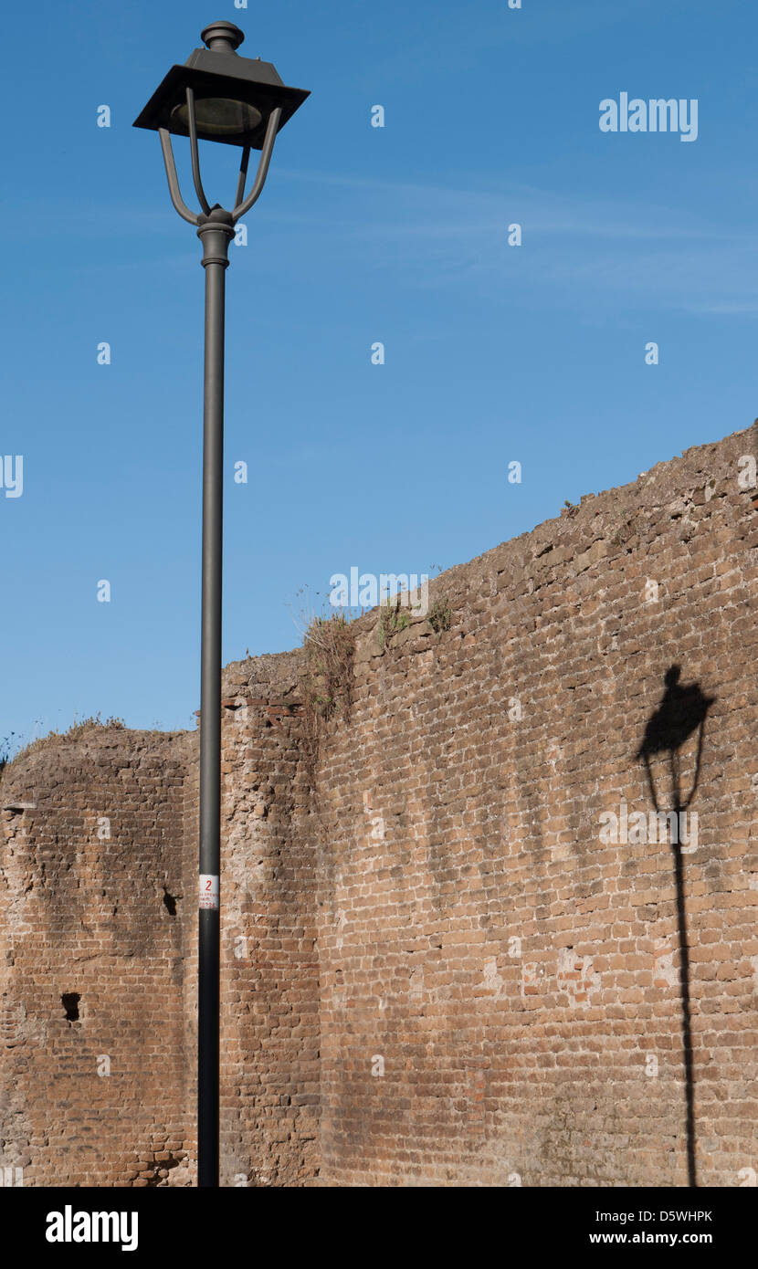 Rome, a shadow of a lamppost reflected on ancient wall Stock Photo