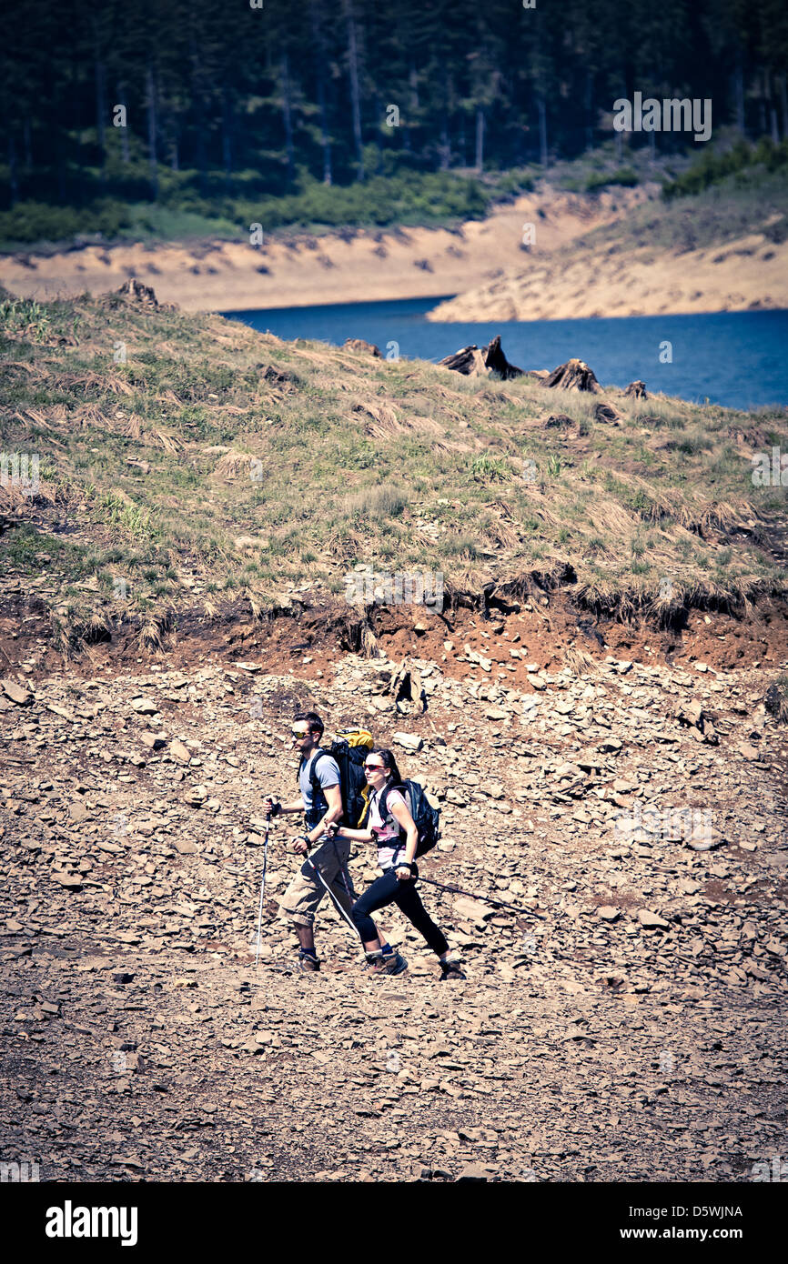 young couple hiking in the wild nature Stock Photo - Alamy
