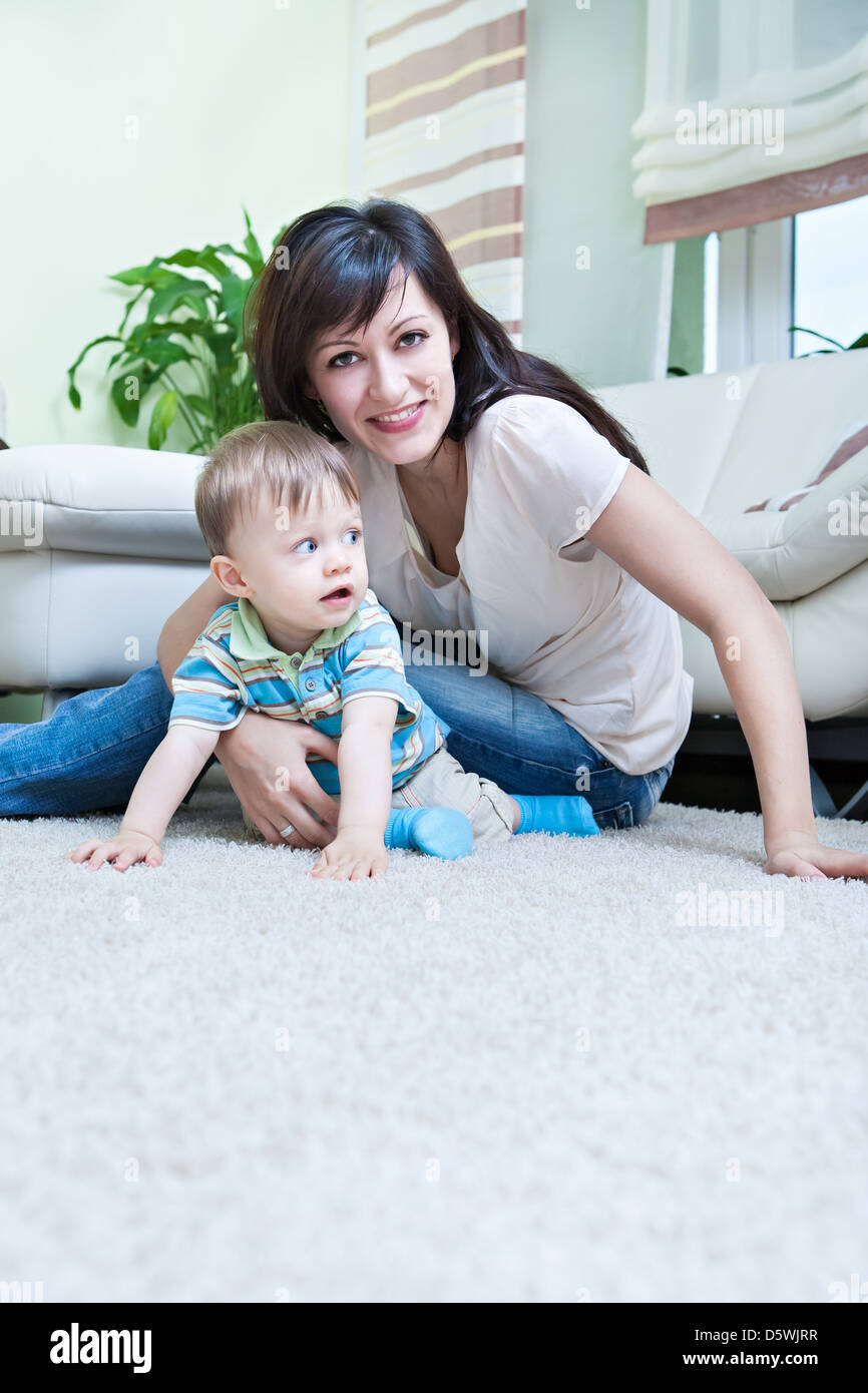 indoor portrait of a young woman with a toddler in the living room Stock Photo