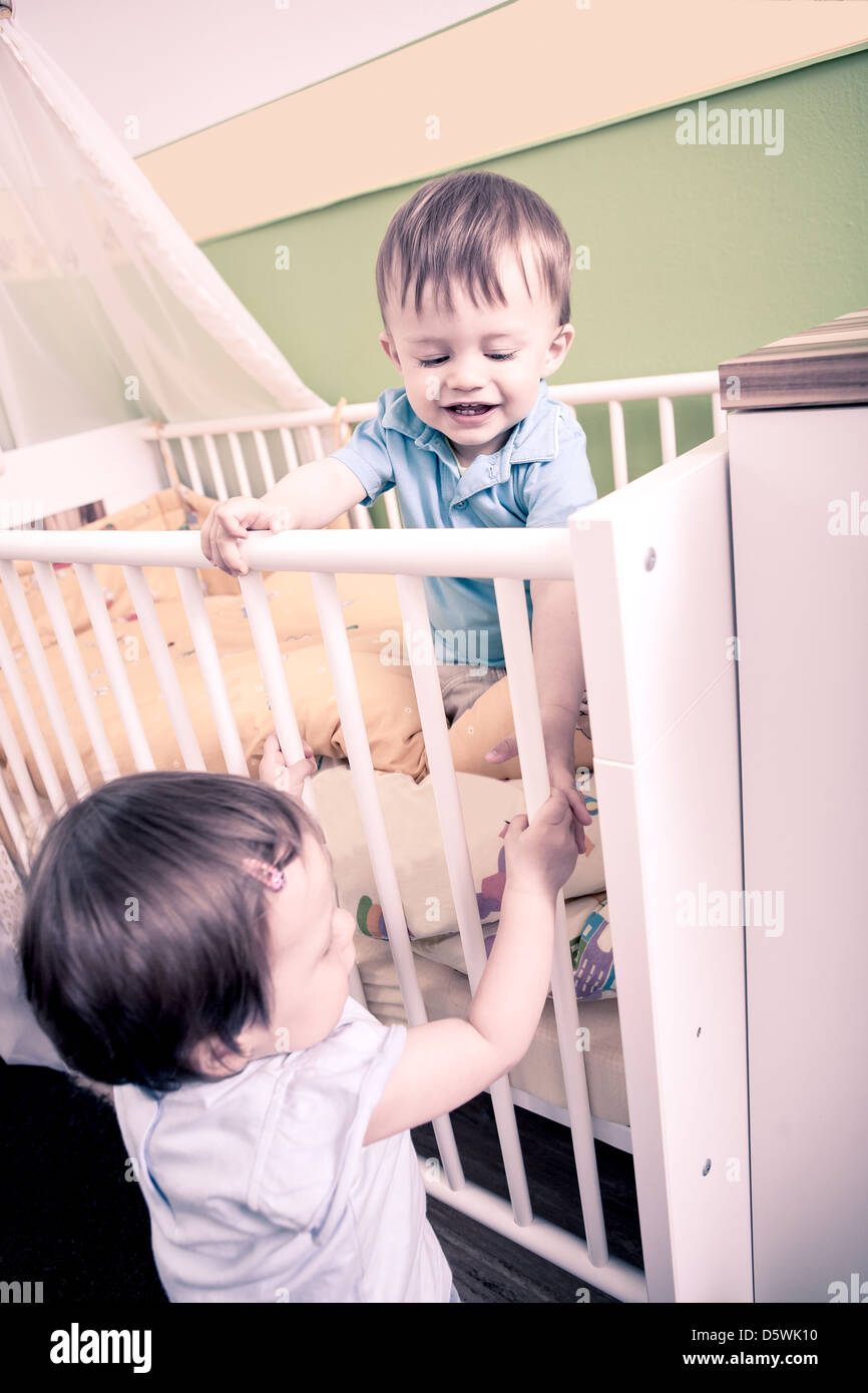 little toddler twins playing in the child's room Stock Photo