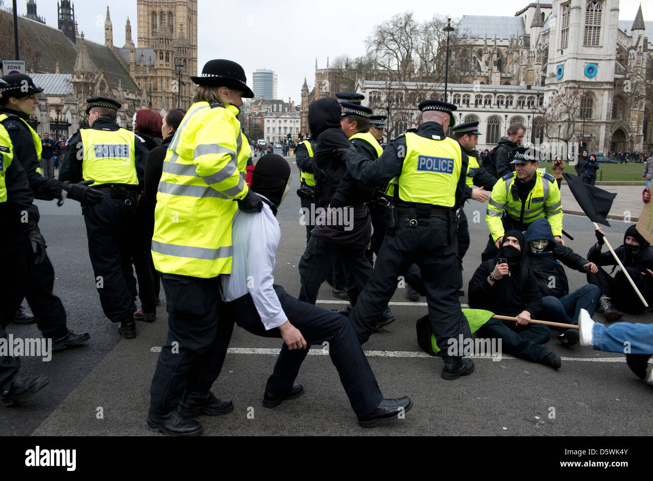 A scuffle between police and protesters, who are campaigning against the new Bedroom Tax on 30th March 2013 Stock Photo