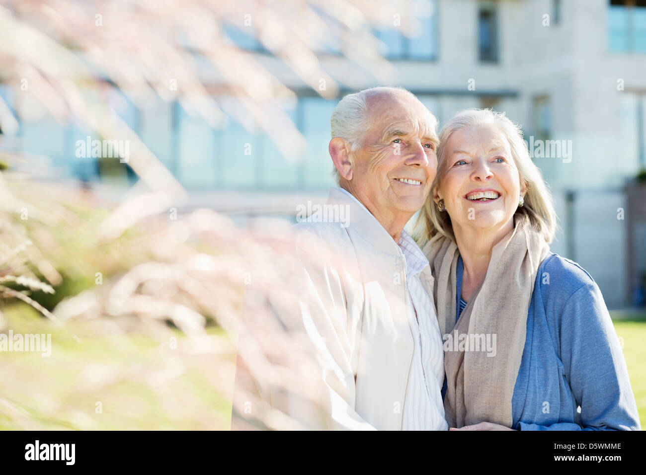 Older couple smiling outdoors Stock Photo