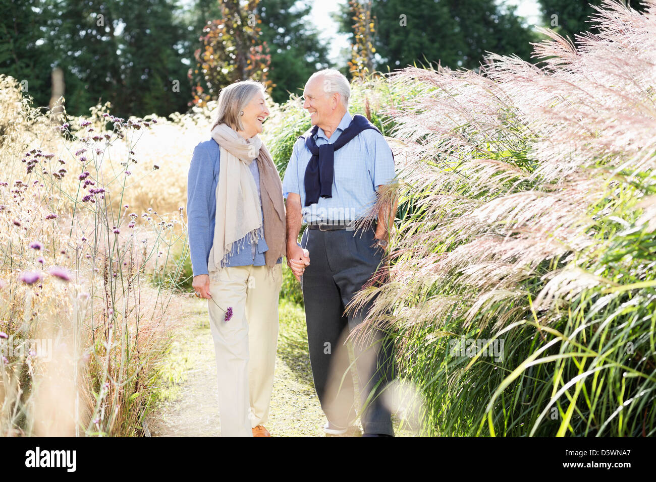 Older couple walking outdoors Stock Photo