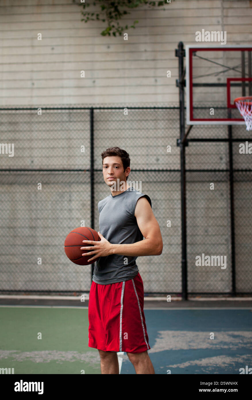 Man standing on basketball court Stock Photo - Alamy