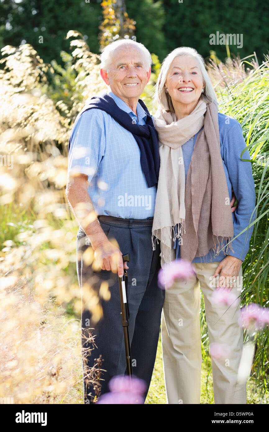 Older couple standing together outdoors Stock Photo
