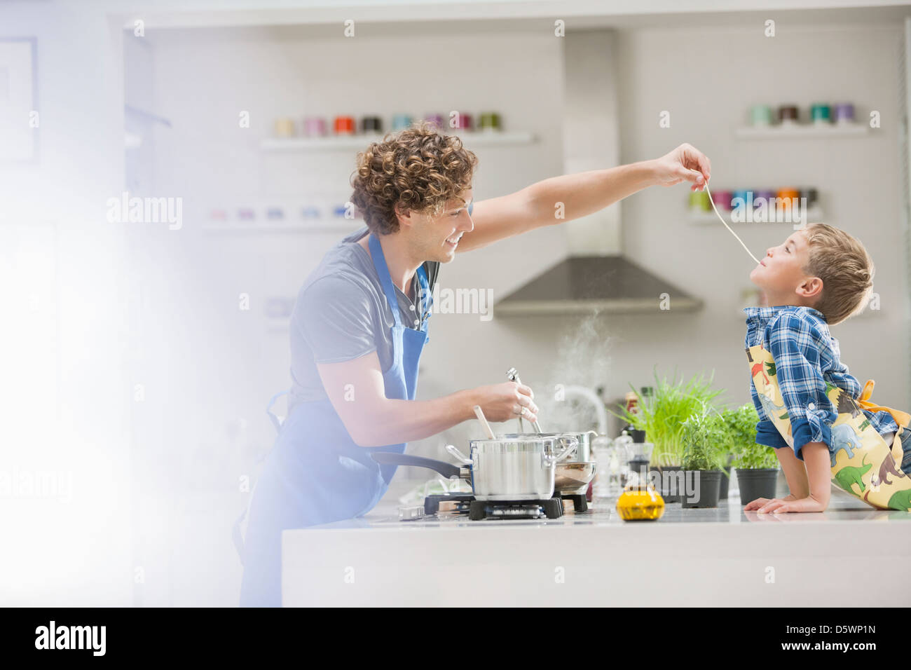 Father and son cooking in kitchen Stock Photo - Alamy