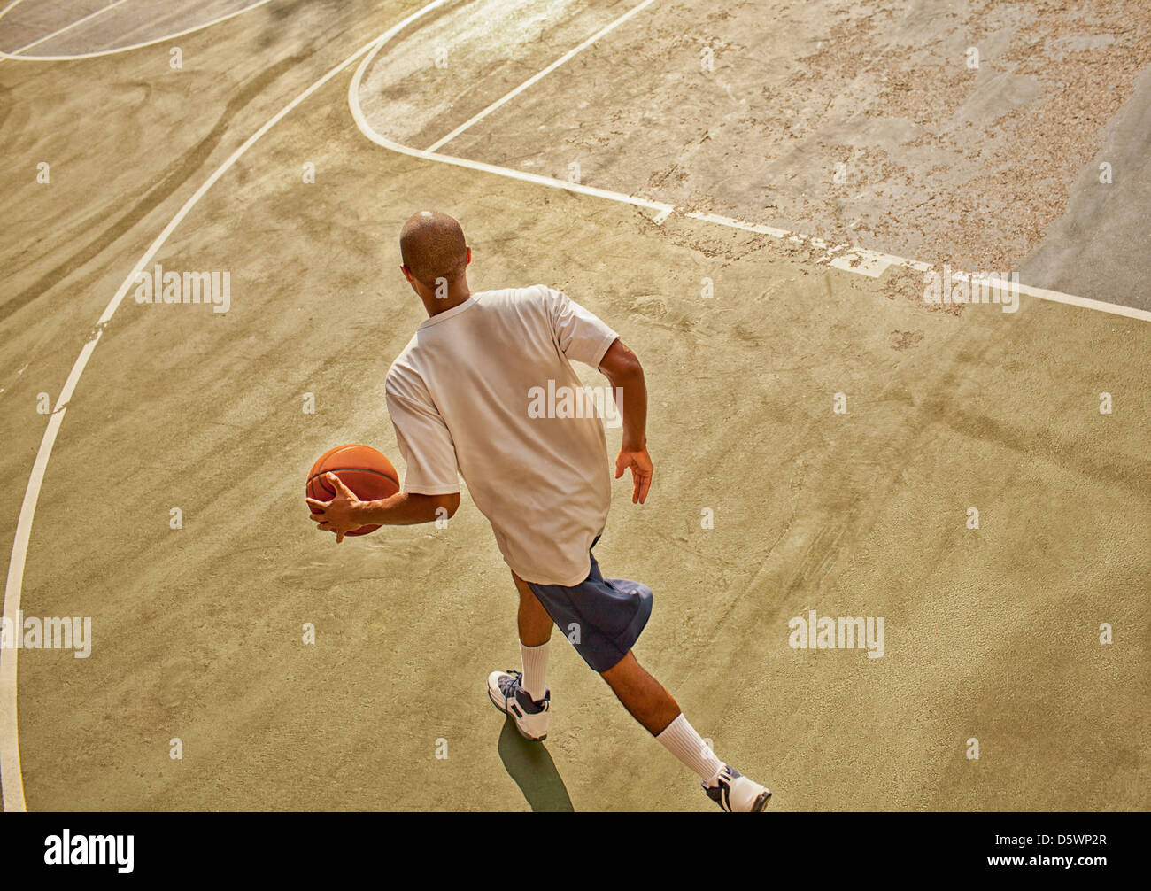 Man playing basketball on court Stock Photo Alamy Man playing basketball on court Stock Photo Alamy