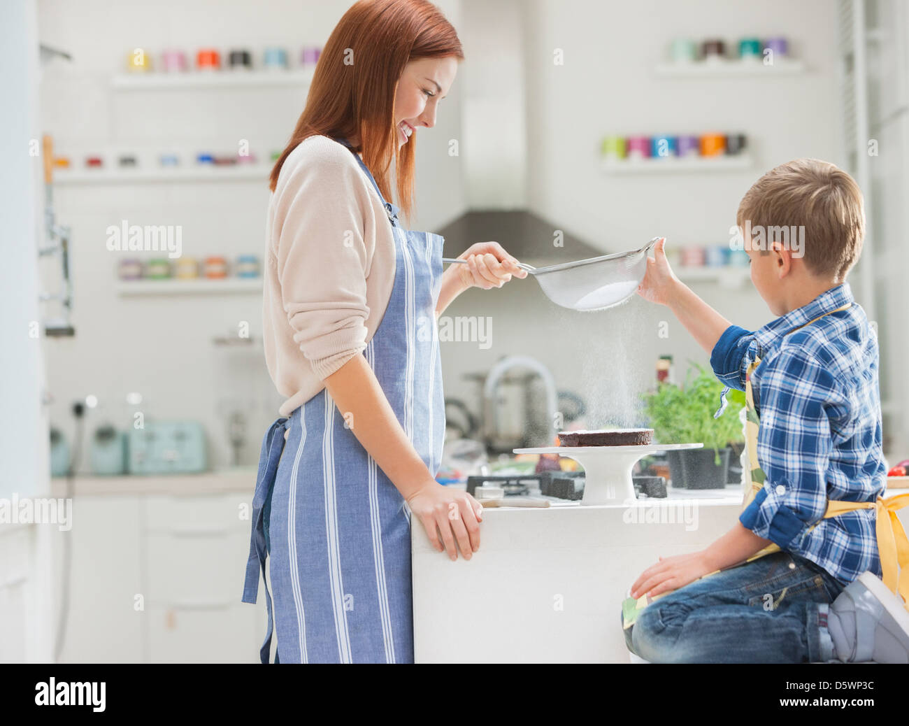 Mother and son baking in kitchen Stock Photo