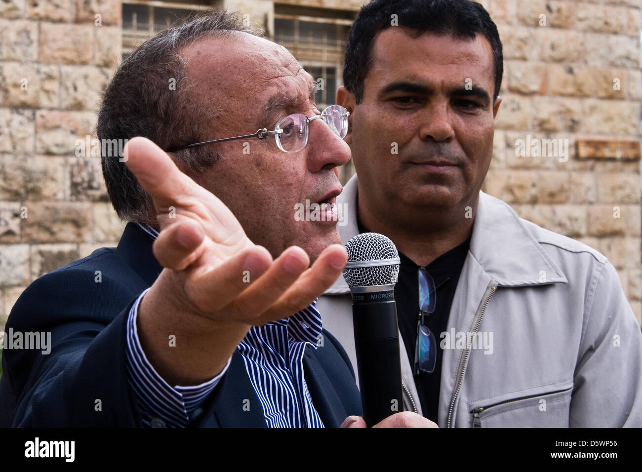 Jerusalem, Israel. 9-Apr-2013. Yussef Asad Radwan, Abu-Haled (C), born 1939 in Deir Yassin, stands before a structure which served as his elementary school until 1948 when the village was invaded and destroyed. Today the structure serves as a Chabad Jewish religious center.   Deir Yassin, a pre-1948 Arab village adjacent to Jerusalem with a population of about 600, was invaded by paramilitaries from the Jewish Irgun and Lehi groups on April 9, 1948 and around 115 villagers were massacred. Credit: Nir Alon/Alamy Live News Stock Photo