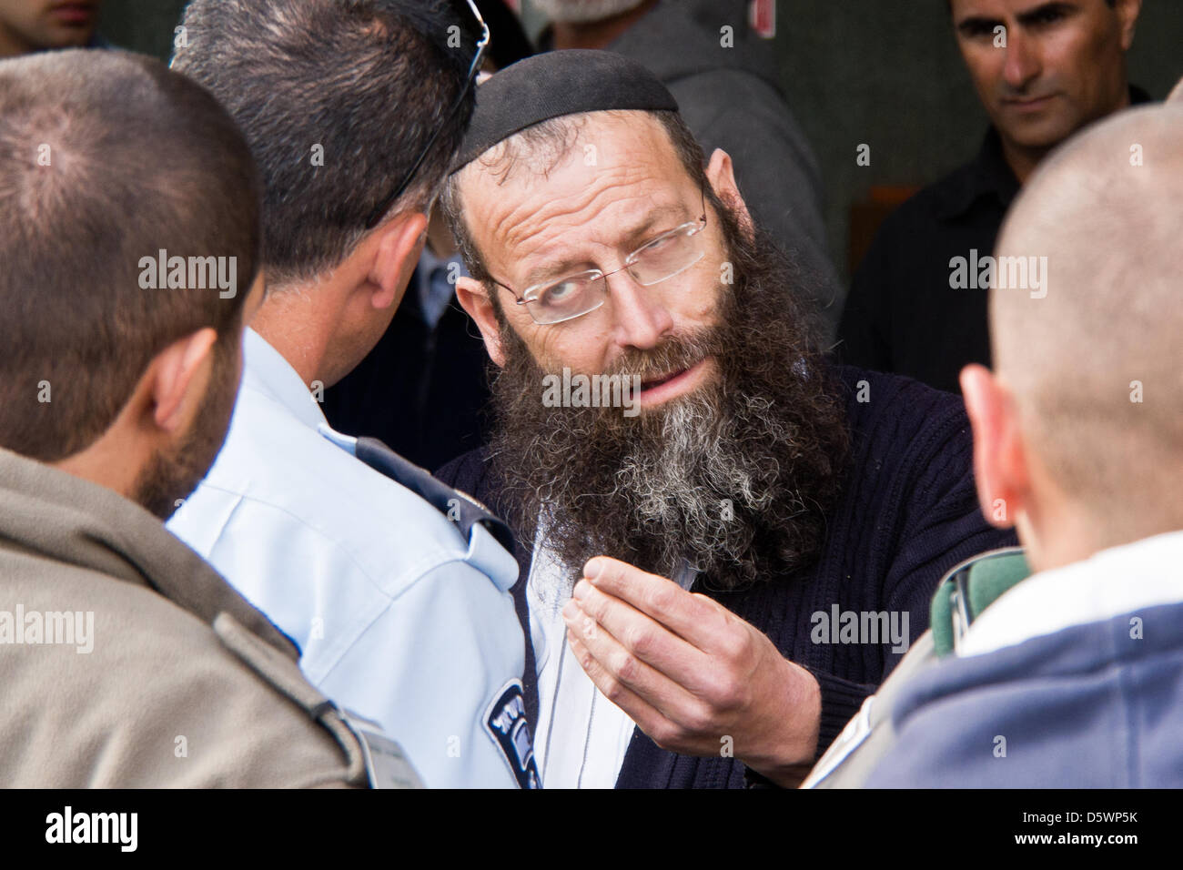 Jerusalem, Israel. 9-Apr-2013. Jewish right-wing activists, lead by Baruch Marzel (C), disrupt a commemoration procession through the historical village of Deir Yassin, organized by Zochrot (Remembering), seeking to raise public awareness of the Palestinian Nakba (Catastrophe).     Deir Yassin, a pre-1948 Arab village adjacent to Jerusalem with a population of about 600, was invaded by paramilitaries from the Jewish Irgun and Lehi groups on April 9, 1948 and around 115 villagers were massacred. Credit: Nir Alon/Alamy Live News Stock Photo