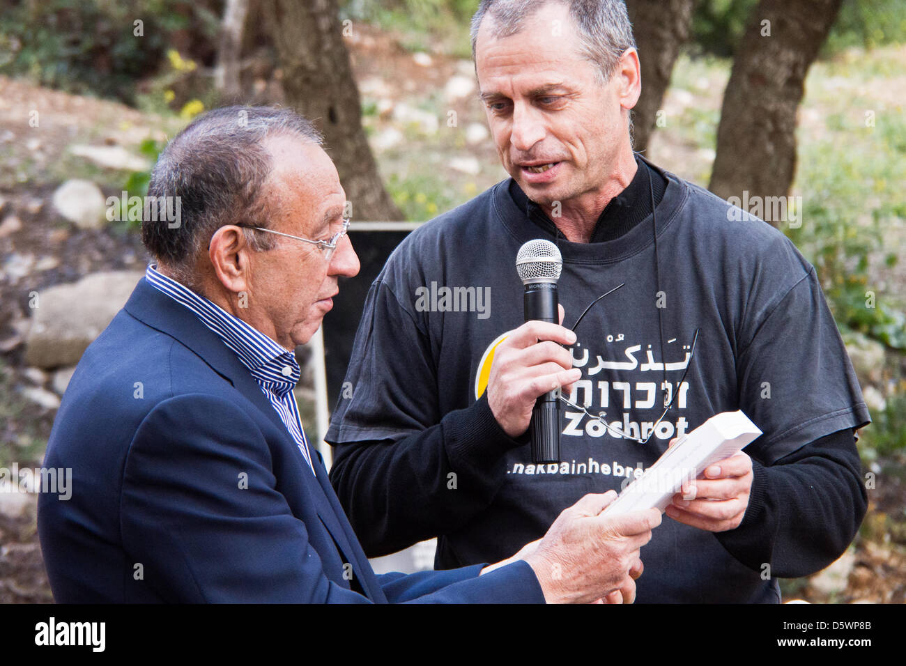 Jerusalem, Israel. 9-Apr-2013. Eitan (R), a founder of Zochrot (Remembering), an NGO seeking to raise public awareness of the Palestinian Nakba (Catastrophe), bestows a gift to Yussef Asad Radwan (L), for taking part in a commemoration procession for the Deir Yassin Massacre.   Deir Yassin, a pre-1948 Arab village adjacent to Jerusalem with a population of about 600, was invaded by paramilitaries from the Jewish Irgun and Lehi groups on April 9, 1948 and around 115 villagers were massacred. Credit: Nir Alon/Alamy Live News Stock Photo