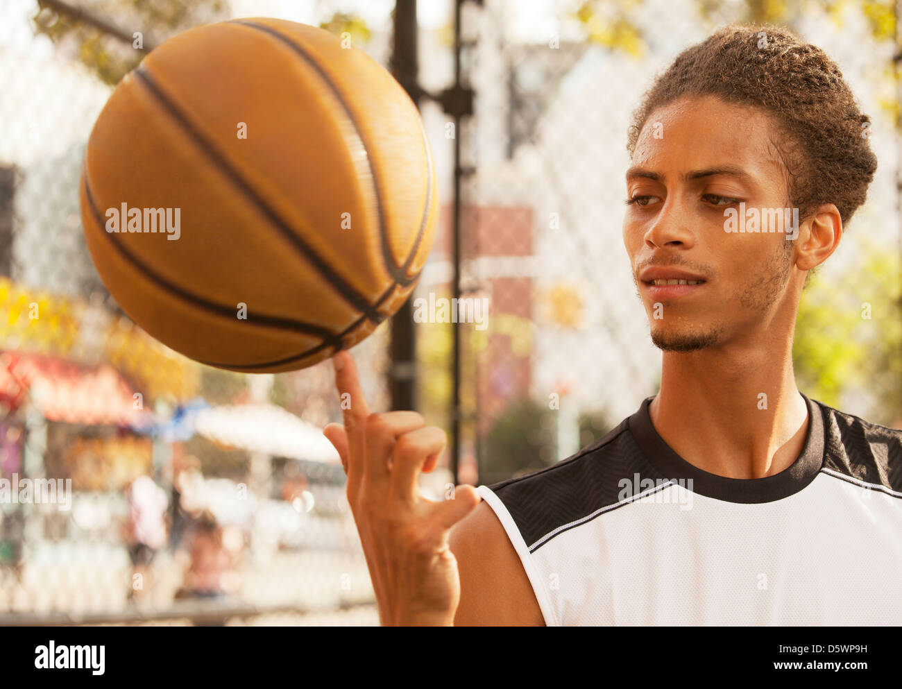 Man spinning basketball on finger Stock Photo Alamy