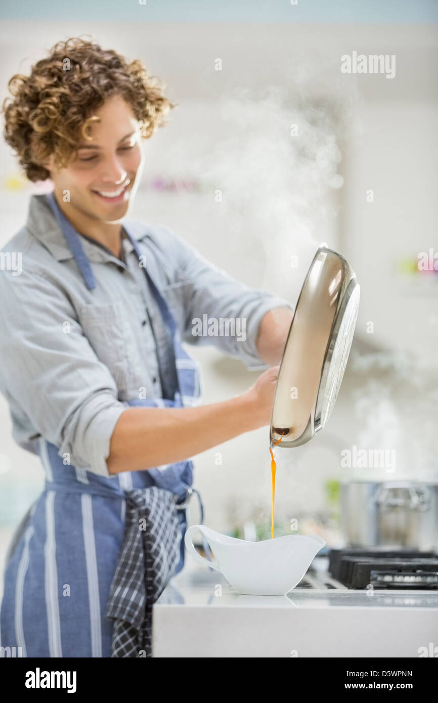 Man cooking in kitchen Stock Photo