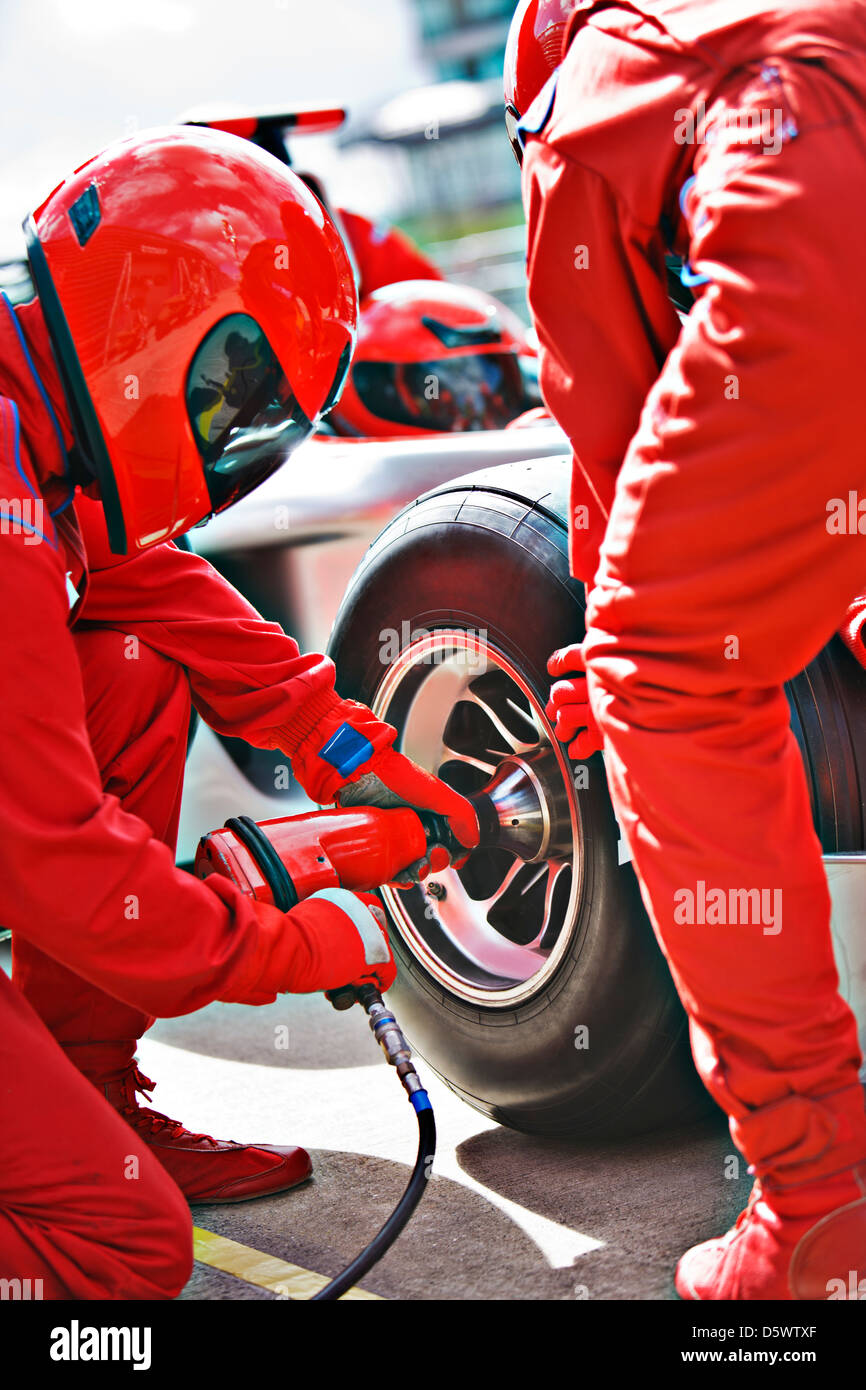 Racing team working at pit stop Stock Photo