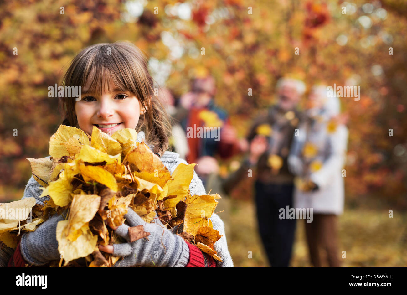Girl playing with autumn leaves in park Stock Photo - Alamy