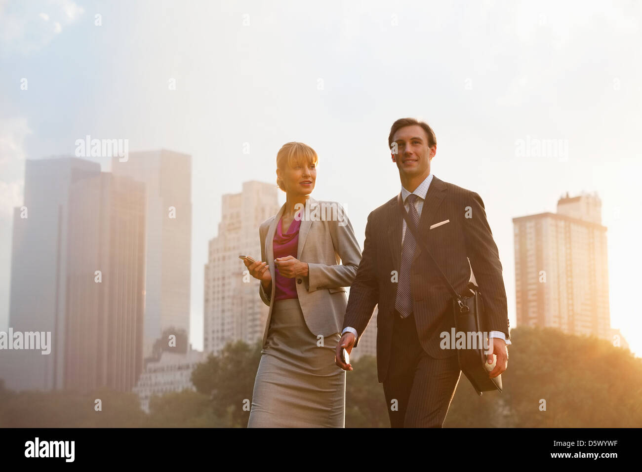 Business people walking in urban park Stock Photo - Alamy