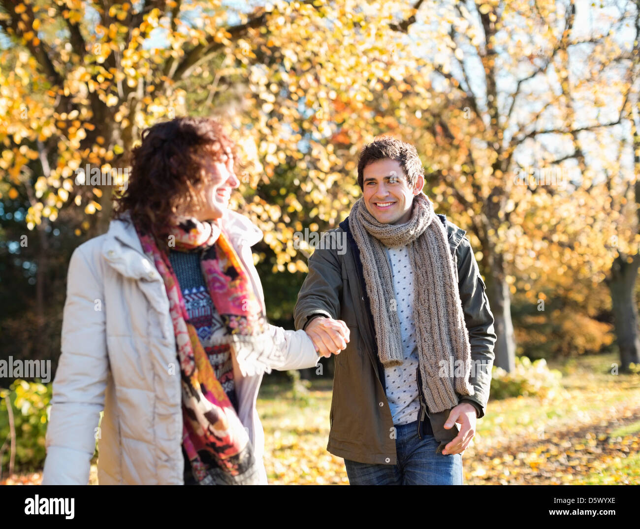 Couple holding hands in park Stock Photo - Alamy