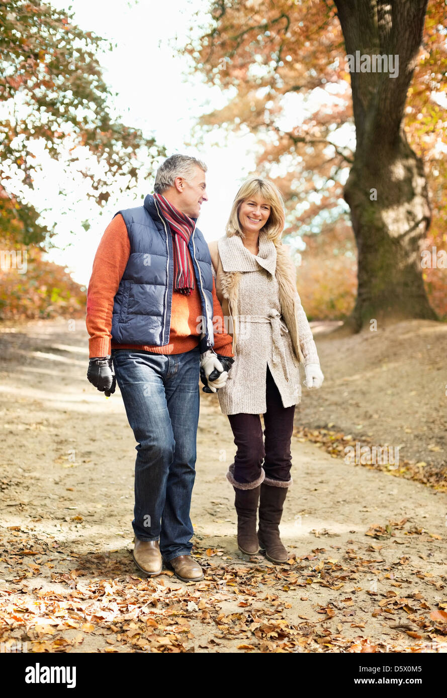 Two older women walking in autumn in the park hires stock photography