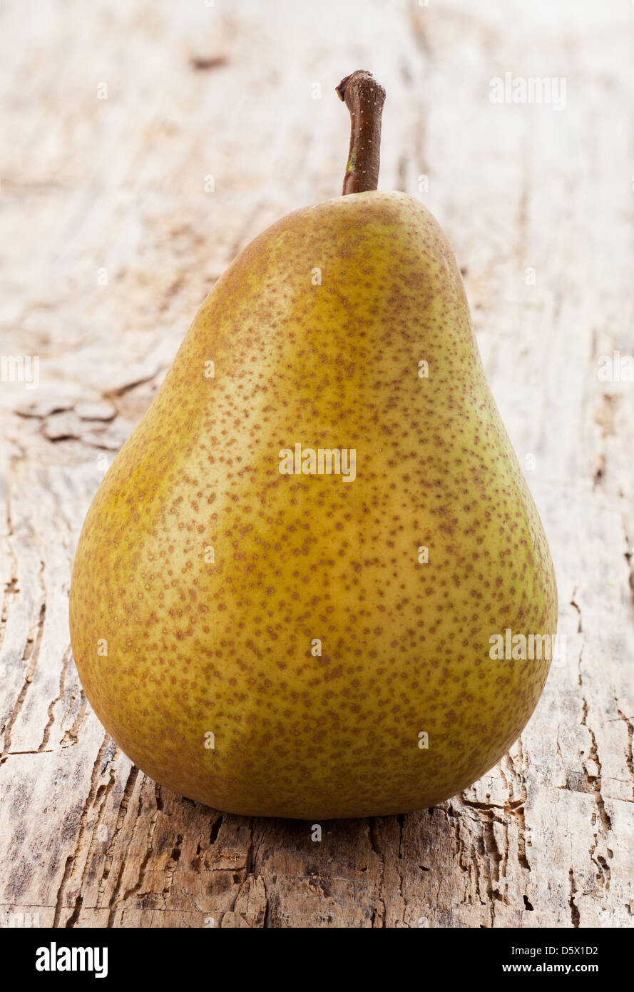 green pear on a wooden table Stock Photo