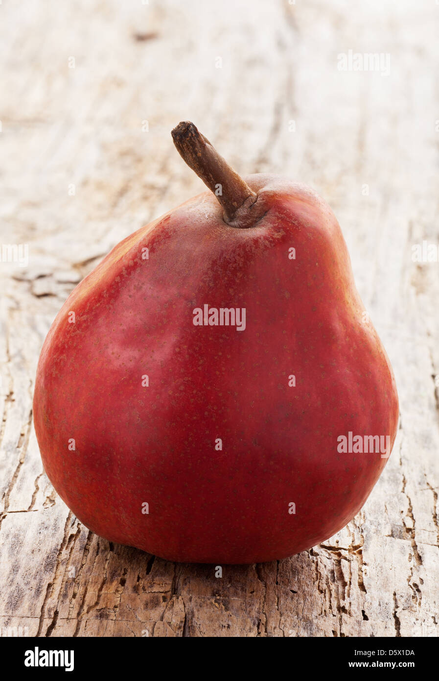 red pear on a wooden table Stock Photo