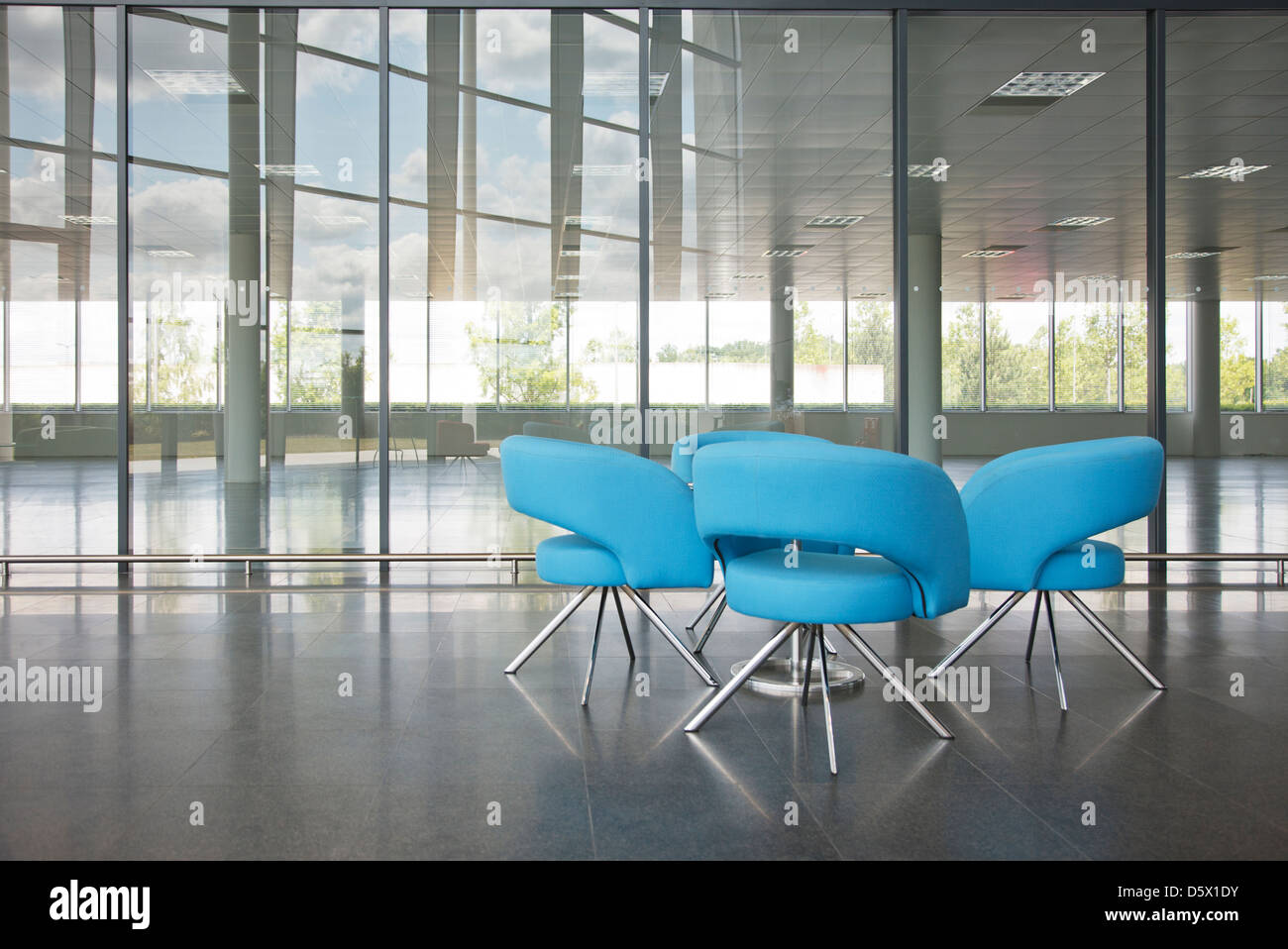 Chairs and table in office lobby area Stock Photo