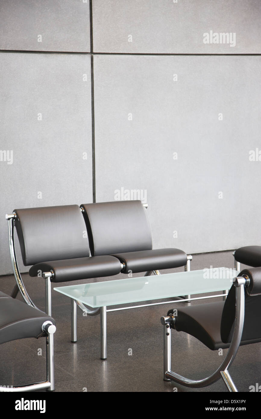 Chairs and table in office lobby area Stock Photo Alamy