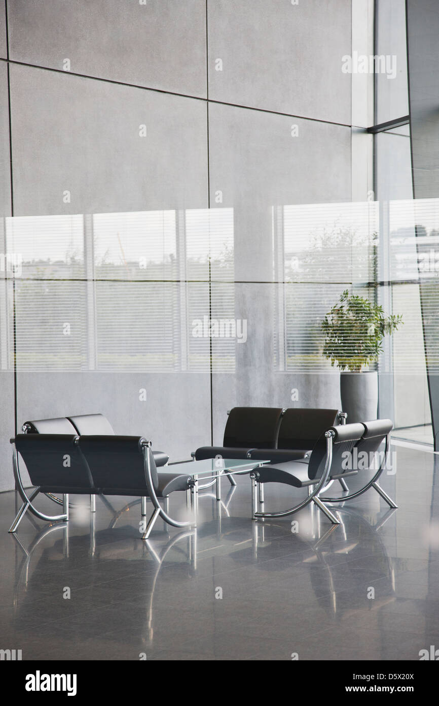 Chairs and table in office lobby area Stock Photo Alamy