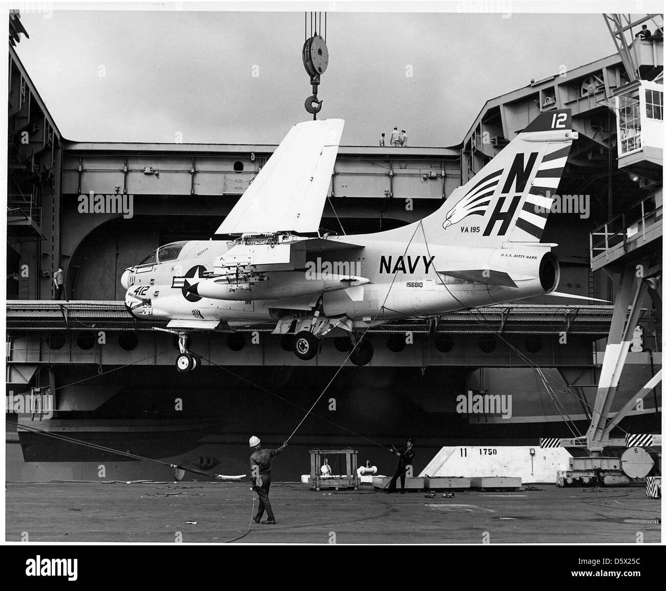 LTV A-7E 'Corsair II' of Attack Squadron (VA) 195 is hoisted aboard the USS KITTY HAWK (CV-63) at NAS North Island. Stock Photo
