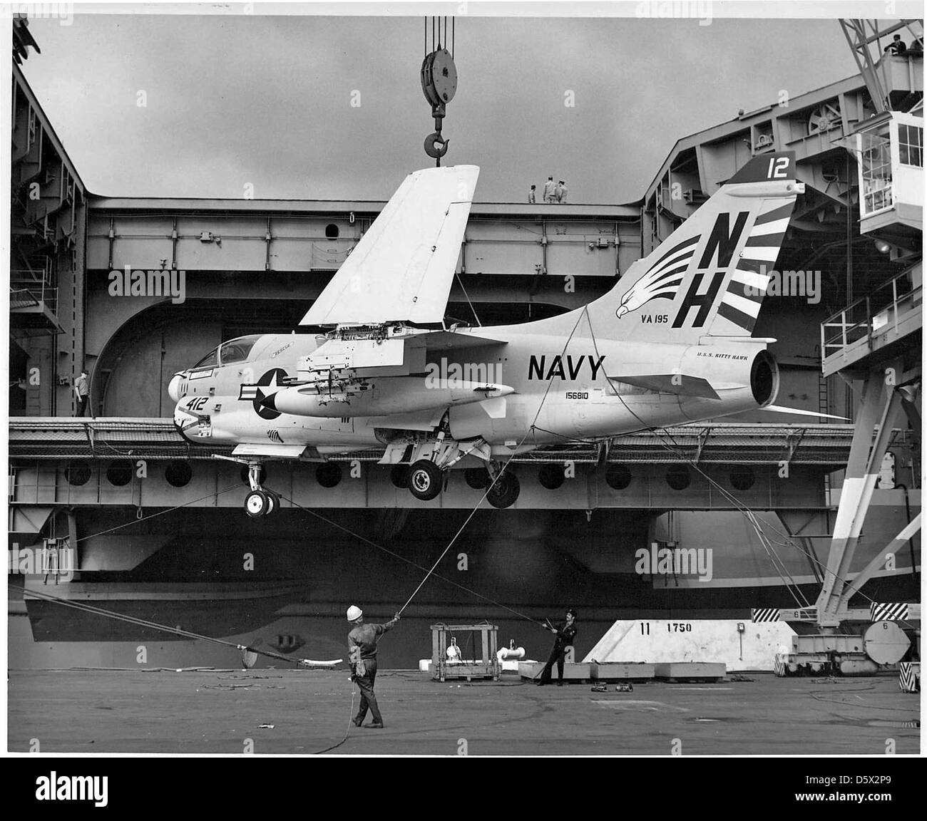 LTV A-7E 'Corsair II' of Attack Squadron (VA) 195 is hoisted aboard the USS KITTY HAWK (CV-63) at NAS North Island. Stock Photo