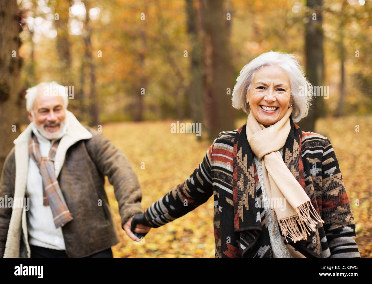 Older couple walking together in park Stock Photo