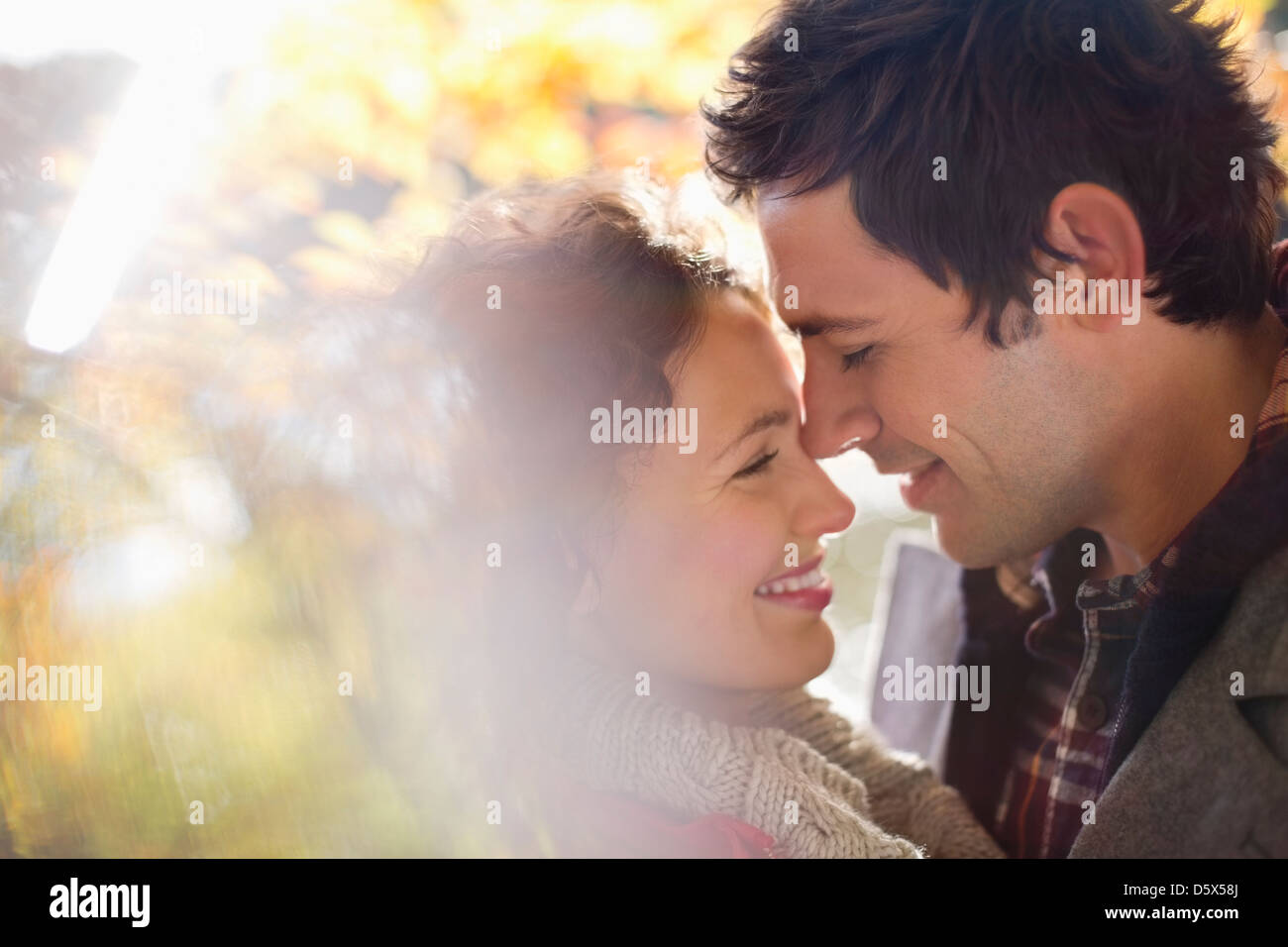 Couple hugging in park Stock Photo - Alamy